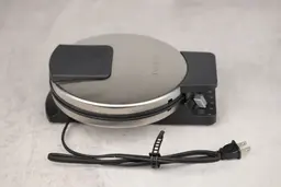 The side profile of the Cuisinart WMR-CA waffle maker, with its power cord at the front.