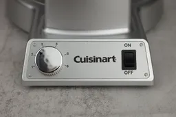 A close-up of the control panel of the Cuisinart WAF-F20P1 Double Belgian waffle maker, with the silvery browning control knob to the left and the black power switch to the right.