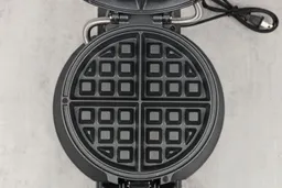 Close-up view of one of the Black and Decker WMD200B’s black, Belgian-style waffle plates.