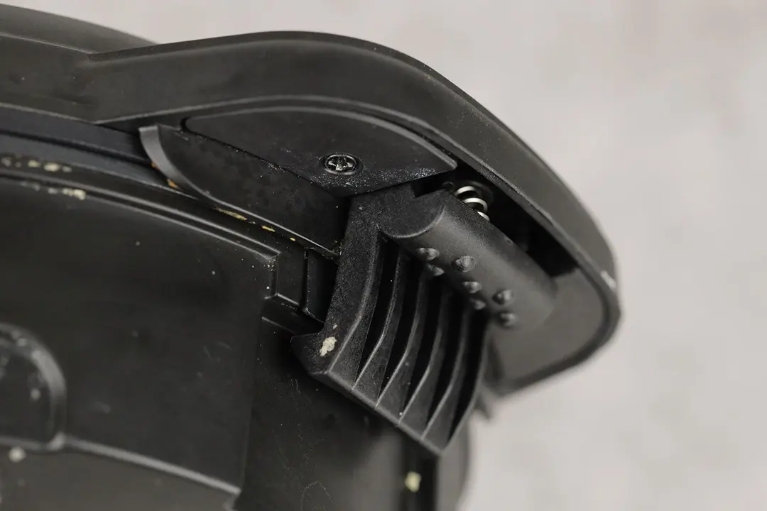 The black, plastic, clamp-style lid lock at the front of the Chefman Anti Overflow Belgian waffle maker.