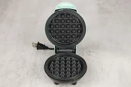 An overview of the DASH Mini’s waffle plates. The plates are black and have a classic-style waffle print.