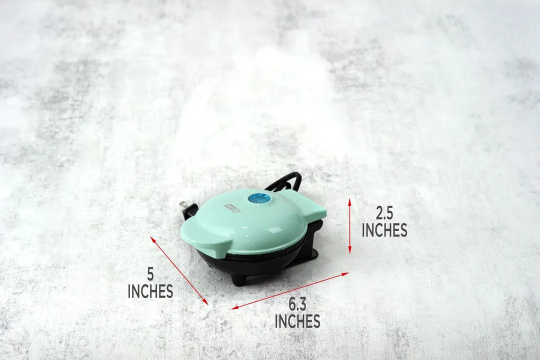 The DASH DMW001AQ Mini waffle maker’s dimensions. The length is 6.3 inches, height 2.5 inches, and width 5 inches.