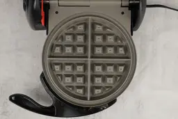 A close-up shot of one of the gray ceramic waffle plates of the Presto Flip Side waffle maker.