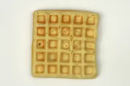 The pale gop bottom crust of a waffle baked for 10 minutes using a batter made from the Birch Benders mix.