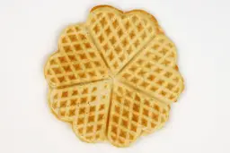 The light brown top crust of a waffle baked for 5 minutes 30 seconds using a batter made from the Birch Benders mix.