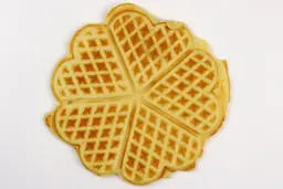 The light brown bottom crust of a waffle baked for 5 minutes 30 seconds using our self-mixed recipe.