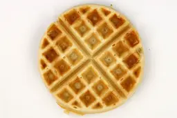 The light brown top crust of a waffle baked for 6 minutes 30 seconds using batter made from Birch Benders mix.