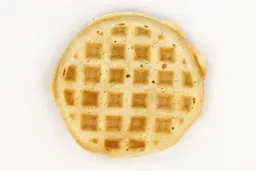 The pale gold top crust of a waffle baked for 8 minutes using a batter made from the Birch Benders mix.