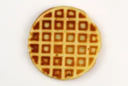 A waffle baked for 5 minutes using our self-mixed recipe. Presented here is its bottom crust with a very dark brown color.