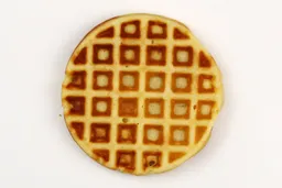 A waffle baked for 5 minutes using our self-mixed recipe. Presented here is its bottom crust with a very dark brown color.
