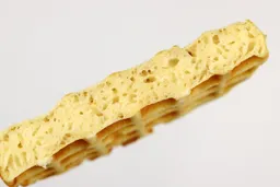 A cross-section of a waffle baked for 5 minutes using our self-mixed recipe. Prominent air bubbles can be seen within.