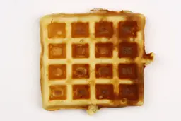 The golden - very dark brown top crust of a waffle baked for 3 minutes using our self-mixed recipe.