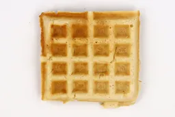 The bottom crust of a waffle baked for 4 minutes using a batter made from Birch Benders mix. It has a very light gold color