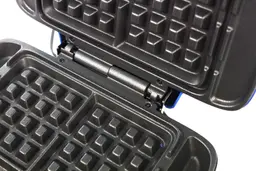 A close-up view of the lid hinges of the Dash No Drip Waffle maker.