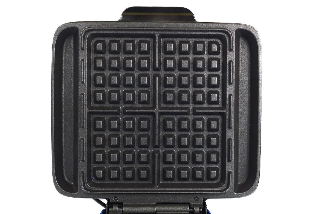 One of the waffle plates of the DASH No Drip waffle maker. It’s separated into four sections, each can cook a small waffle.