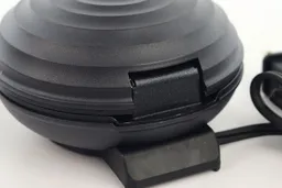 The back of the Crownful waffle maker’s lid hinge. It is currently in the closed position.