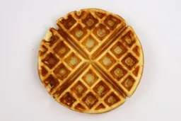 A waffle baked for 5 minutes using our self-mixed recipe, with black charring inside its pockets.