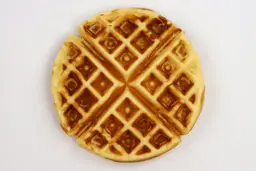 A waffle baked for 5 minutes using our self-mixed recipe, with black charring inside its pockets.