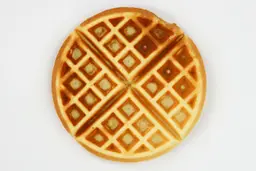The dark brown top of a waffle cooked by the Hamilton Beach 26031 waffle maker in 5 minutes.