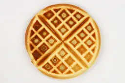 The mottled, dark brown bottom of a waffle cooked by the Hamilton Beach 26031 waffle maker in 5 minutes.