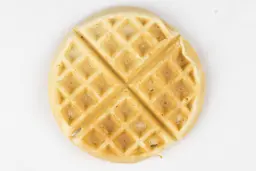 The light gold top of a waffle cooked by the Hamilton Beach 26031 waffle maker in 6 minutes using the Birch Benders mix.