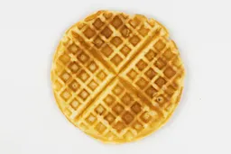 The very dark brown top crust of a waffle baked for 3 minutes using our self-mixed recipe.