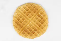 The golden brown bottom crust of a waffle baked in 3 minutes using a batter made from the Birch Benders mix.