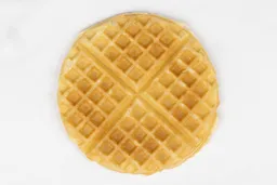 The golden brown bottom crust of a waffle baked in 3 minutes using a batter made from the Birch Benders mix.