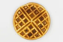 The very dark brown-dark gold top crust of a waffle baked for 5 minutes using our self-mixed recipe.