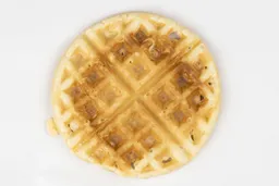The very light gold-dark brown top crust of a waffle baked for 3 minutes using a batter made from the Birch Benders mix.