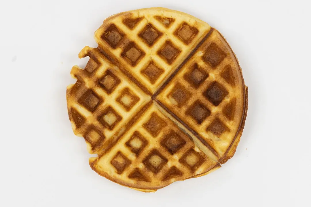 The very dark brown top crust of a waffle cooked in 5 minutes.