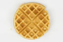 The dark brown top crust of a waffle baked in 7 minutes and 30 seconds.
