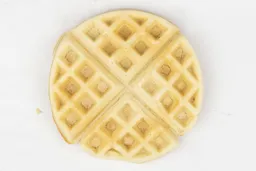 The pale yellow crust of a waffle baked in 7 minutes and 30 seconds.
