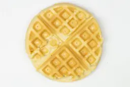 The golden top crust of a waffle baked for 8 minutes using a batter made from the Birch Benders mix.