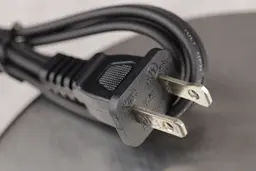 The Type A plug attachment of the Oster Belgian waffle maker’s power cord.