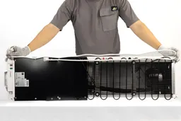 Man holding a white electric cord of a water cooler dispenser doubled across the length of the horizontally resting machine.