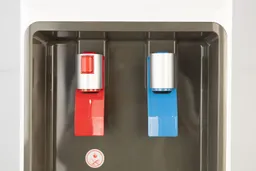 A close up of two dispensing levers on a water cooler dispenser. The left red lever dispenses hot water and the blue cold.