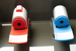 Underview of two nozzles on a water cooler dispenser.