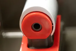 Close up view of the underneath of a hot water nozzle on a water cooler dispenser.