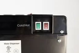Color coded hot and cold water switches with relief script on the rear of the Avalon A4 water cooler dispenser.