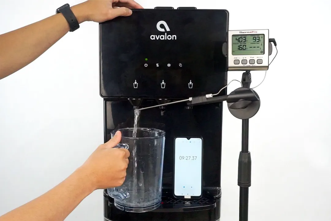 Water temperature being measured as hot water flows out the nozzle of a water cooler dispenser. submit