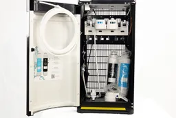 Close up of the cabinet interior of the Avalon A5 water cooler dispenser with a filtration system and unassembled parts.