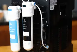 A picture showing how two water filters at the rear of a bottleless water cooler dispenser are connected.