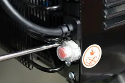 How to unscrew the safety cap on the drainage port of a small countertop bottleless water cooler dispenser.