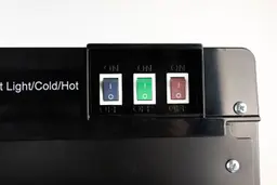 Night light, hot and cold water switches on the rear right side of a water cooler dispenser.