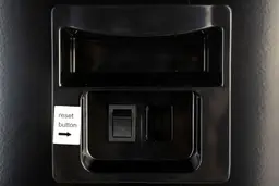 The filter reset button on the left side of the Avalon A8 countertop bottleless water cooler dispenser.