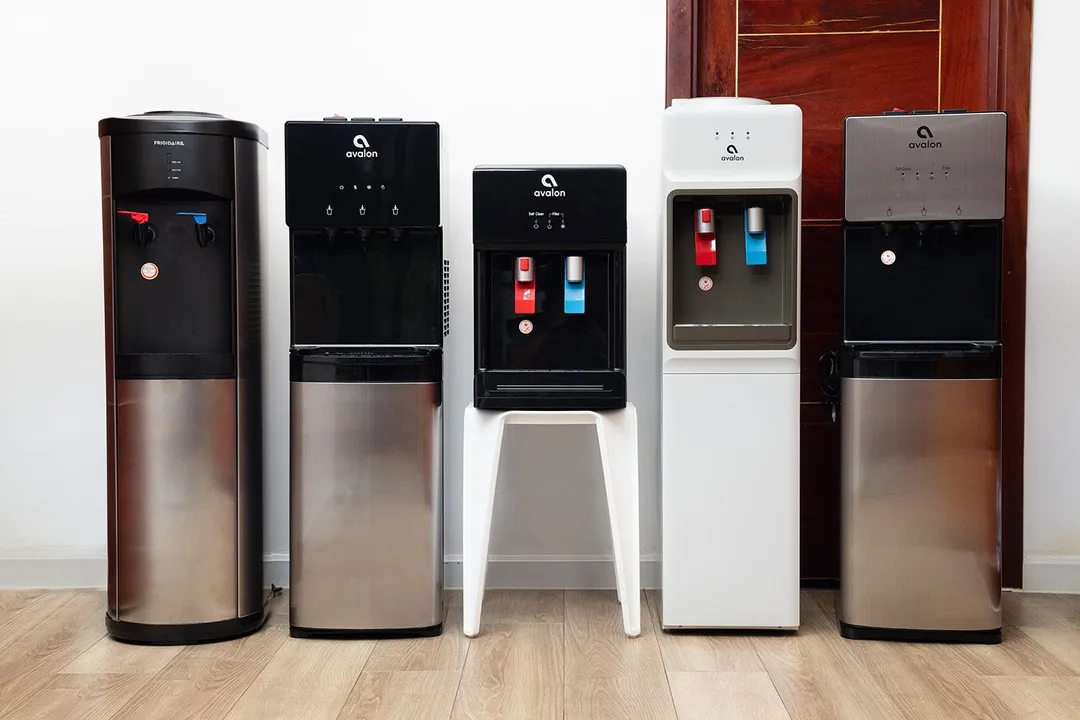 Five different water cooler dispensers standing next to each other in a row