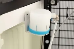 Bottle cap and water probe of a bottom loading water cooler dispenser hanging from a cabinet door bracket.