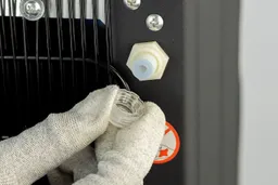 The safety cap on the rear drainage port of the Euhomy self-cleaning water cooler dispenser.