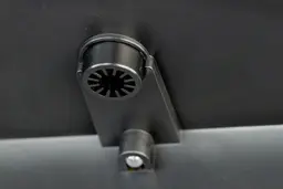 Close up of a water nozzle of a button operated water cooler dispenser.